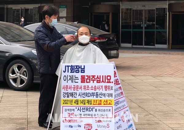 김대근 시선RDI 대표가 26일 하나금융그룹 명동 사옥 앞에서 하나은행을 규탄하며 머리를 밀고 있다 ⓒ 시사오늘